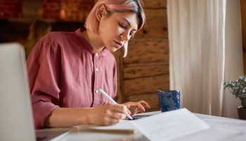 student girl writting on a paper
