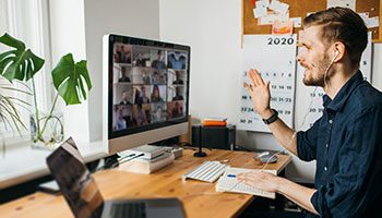 man on a video conference call with customer experience colleagues